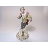 An early 19th century Derby figure of male character in 18th century style costume, his jacket