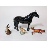 A Beswick type model of a black fell pony, a Beswick fox, a Beswick rabbit and a Royal Worcester