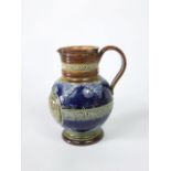 A late 19th century Doulton Lambeth blue ground jug commemorating the 1897 diamond jubilee of