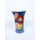 A Royal Doulton blue ground vase of flared form with polychrome painted flower head detail,