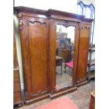 A good quality early Victorian mahogany breakfront triple wardrobe, the central door enclosing a