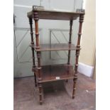 A 19th century French three tier etegere with turned column supports, each shelf brass banded and