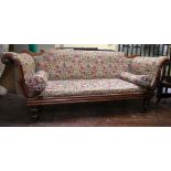 A Regency mahogany scroll end sofa with carved show wood frame raised on turned supports with