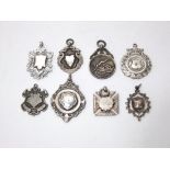 Eight silver fobs