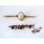 Two 9ct bar brooches, one set with garnets and the other with a large opal, in original box, 4g