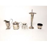 A silver drum mustard pot, open salt, trumpet shaped vase, inkwell and cream jug with loop handle