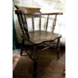 A 19th century Windsor smokers bow elbow chair with elm seat, turned spindle mouldings, supports and