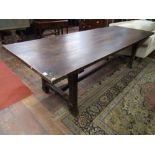 An old English style refectory table, the heavy plank top raised on four square cut supports on