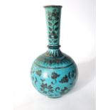 A middle eastern type pottery vase with globular body and drawn neck with painted stylised floral