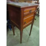 A late 19th century bedside/lamp table enclosed by a panelled door and frieze drawer and square