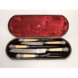 An Elkington & Co silver and ivory handled carving set, maker Hukin & Heath, within a baize lined