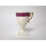 An unusual 19th century Belleek custard type cup with painted pink border against on an ivory