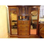 A substantial Victorian walnut breakfront triple compactum wardrobe, the central tower of drawers