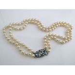 A double string of quality cultured pearls with white metal clasp set with two aquamarines, the