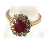 A ruby and diamond cluster ring marked 750, size O, 5.5g