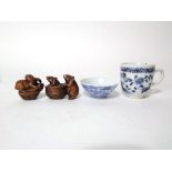 A small oriental open bowl with painted blue and white exotic bird detail and four character mark to