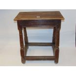 An antique oak coffin/joint stool raised on four turned and tapering supports, 50 cm max