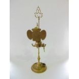 An interesting eastern brass oil lamp fitted with a screen and revolving globular sconce holder,