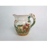 An early 20th century Wedgwood relief moulded and painted jug with hunting scene decoration and