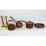 A 19th century copper kettle, various copper pans and a pair of brass Gothic style candlesticks