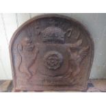 A heavy cast iron fire back with Tudor Rose detail, lion and unicorn mounts 1571, 70 cm diameter