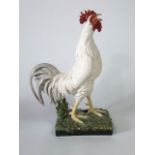 A large 20th century Portuguese majolica type figure of a striding white cockerel,