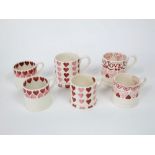 A collection of Emma Bridgewater mugs, all with pink heart decoration comprising four small mugs and