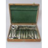 An oak canteen fitted with various silver plated flatware