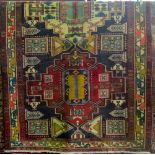 A Persian wool carpet with multi medallion panels upon a black ground within running borders,