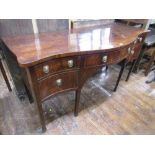 An early George III mahogany serpentine sideboard fitted with an arrangement of five drawers with