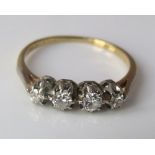 An 18ct four stone diamond ring, size N, 2g