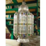 A pair of decorative Moroccan hanging lanterns with pierced and fretted detail with coloured glass