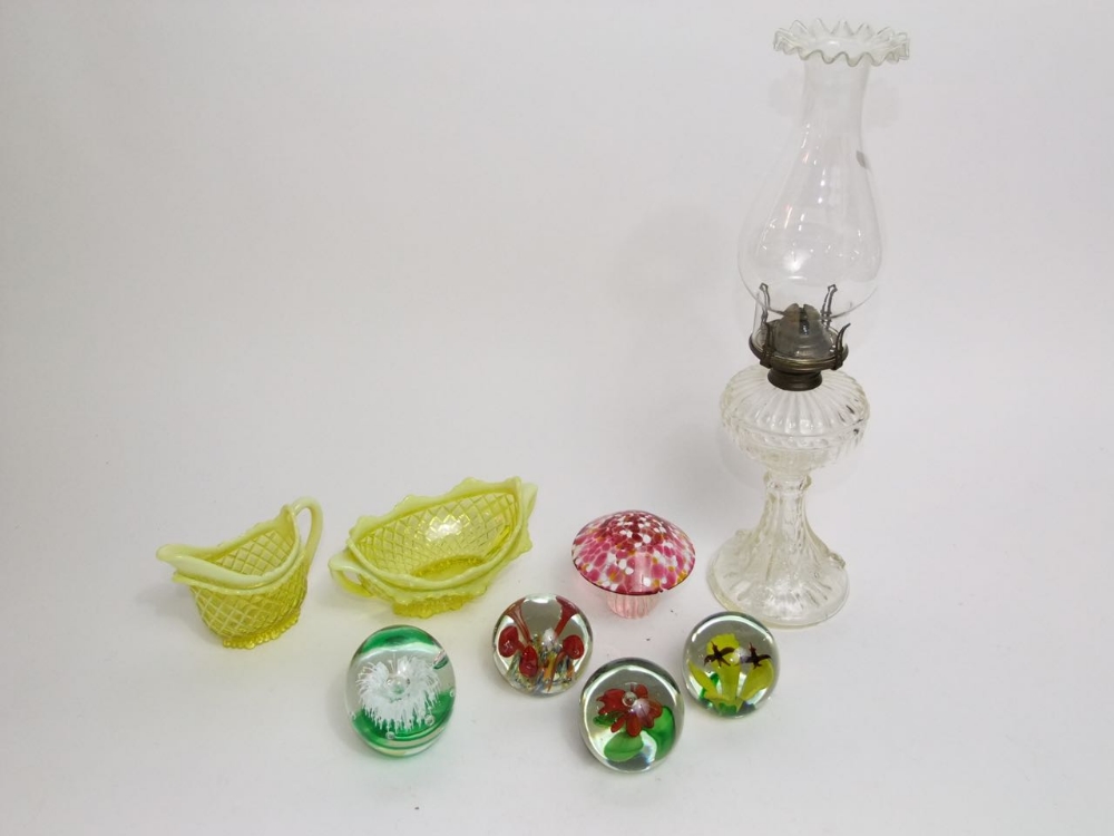 Five various glass paperweights together with two vaseline glass pieces to include a milk jug and