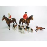 A Beswick model of a huntsman on a horse together with a further Beswick model of a jockey in red