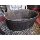 An oval oak coopered tub with handle, 100 cm max