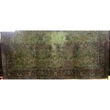 A large Persian style carpet with multi floral detail within wide running borders, 420x340cm approx