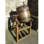 A Victorian butter churn on stand in oak and with banded finish by Hathaway