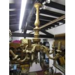 A carved timber six branch ceiling light with carved and later painted finish