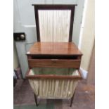 A Regency mahogany ladies sewing table with rising lid and pleated silk wool bag below and rising