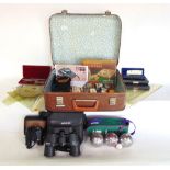 A suitcase containing a collection of stationers and field equipment to include binoculars,