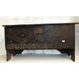 A simple 18th century oak six plank coffer with geometric carved detail, 95 cm wide