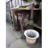 A Victorian cast iron pub table with pierced detail and moss encrusted timber top together with