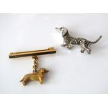 A 9ct brooch with suspended model of a dachshund on chain, 4g, together with a marquisette dachshund