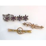 Two 9ct gold seed pearl bar brooches, 4g. Together with a further brooch set with amethysts.