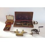 A box containing a selection of antique watchmakers precision tools.