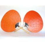 A pair of oriental lacquered fans with bamboo shaft handles.