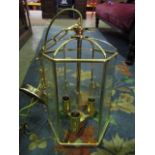 A pair of contemporary brass framed hall lanterns of hexagonal form with bevelled glass panels