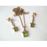 A peridot demi parure in 9ct gold comprising necklace and drop earrings, 5g total