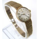 A 1960s ladies omega 9ct gold wrist watch on a gold mesh strap in original box with papers dated