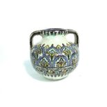 An Eastern two handled pottery vessel with painted decoration in tones of blue, ochre and turquoise,